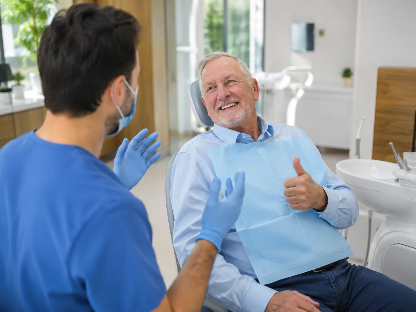 dental-implants-ipswich-hero Smiling patient discussing dental implant treatment with a dentist